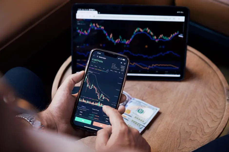 Ibu rumah tangga memegang smartphone dengan grafik investasi di layar